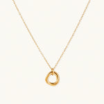 Load image into Gallery viewer, Delicate gold-plated necklace with three interlocking circle rings forming a minimalist knot pendant on cream background