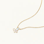 Load image into Gallery viewer, Gold-plated butterfly pendant with iridescent mother of pearl inlay on delicate chain against cream background.