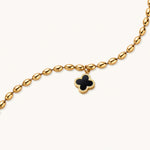 Load image into Gallery viewer, 18K gold-plated oval bead bracelet with a four-leaf clover charm in mother-of-pearl or black enamel, adjustable lobster clasp, on white background.