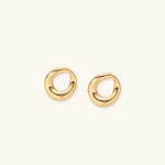 Load image into Gallery viewer, Pair of polished 18K gold-plated stainless steel teardrop earrings with hollow centers on cream background