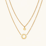 Load image into Gallery viewer, Gold layered necklace set with sunburst and smiley face pendants on delicate chains against white background.
