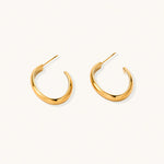 Load image into Gallery viewer, Chunky tubular hoop earrings in warm 14K gold-plated finish with smooth polished surface on cream background.