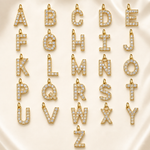 Load image into Gallery viewer, Dainty Diamond Letter Initial Lariat Necklace gold A to Y alphabet pendant charms with clear rhinestones arranged on cream satin.