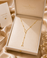 Load image into Gallery viewer, Dainty Diamond Letter Initial Lariat Necklace gold Y-necklace with heart connector and dangling A charm in an open cream jewelry box.