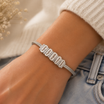 Load image into Gallery viewer, Personalized Family Name Herringbone Chain Bracelet silver-toned snake chain bracelet with engraved LOVE nameplates in sparkling clear stones worn on wrist.