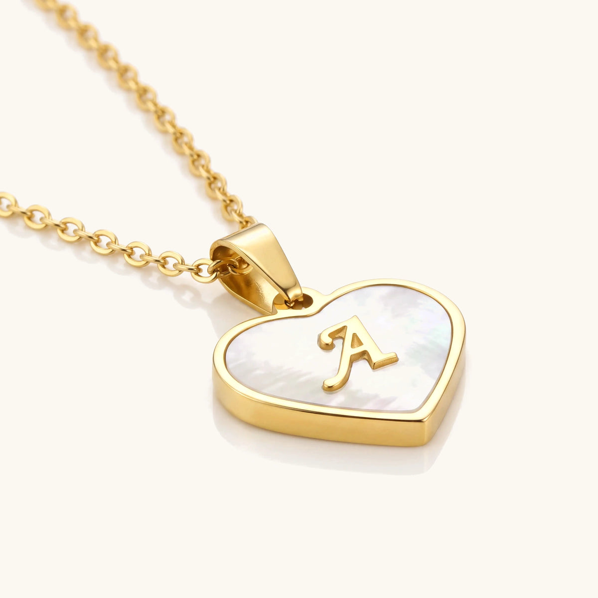 18k Pearl Heart Initial Letter Necklace – angled close-up of the pearl heart and gold bezel