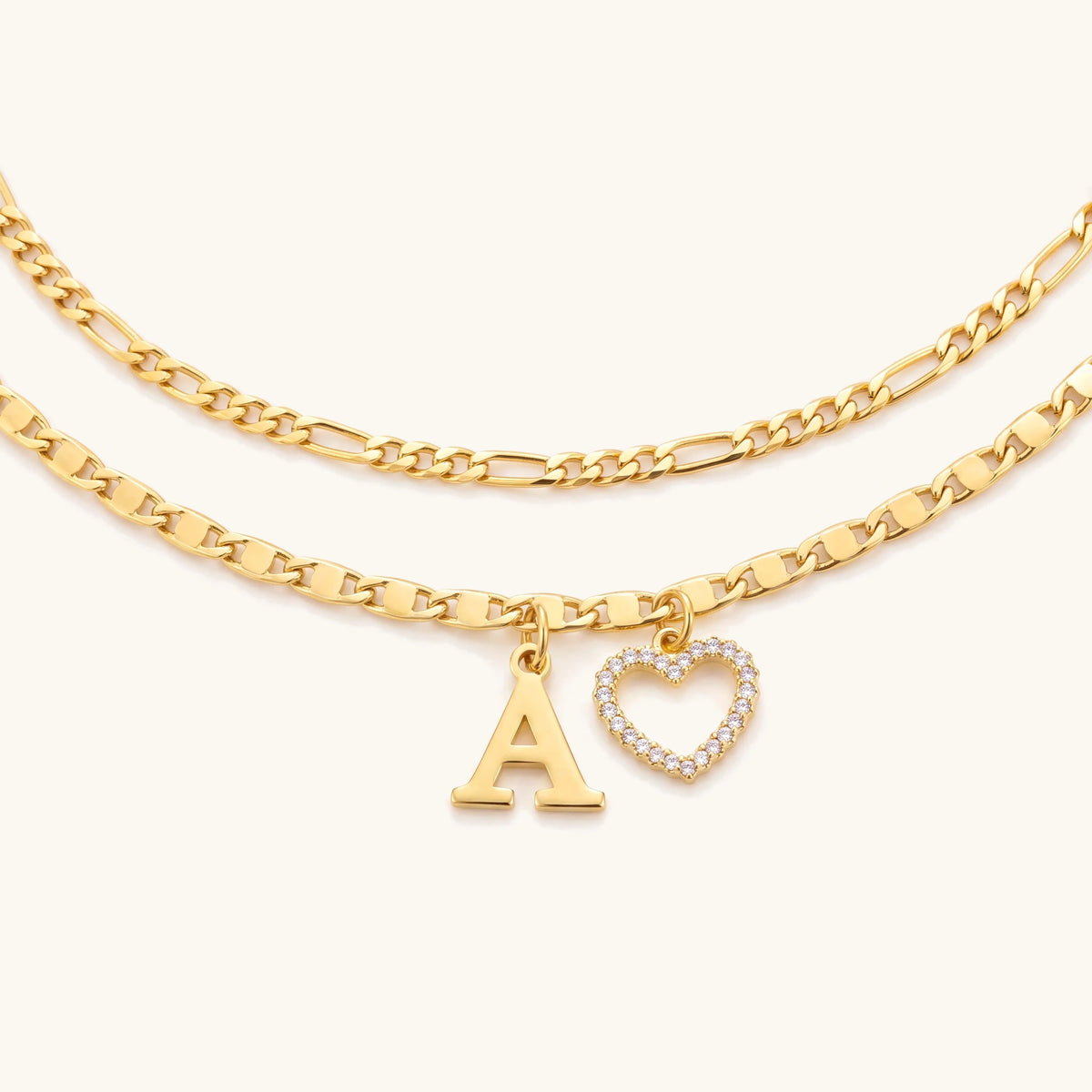 Layered gold anklet with initial letter A charm and crystal heart charm