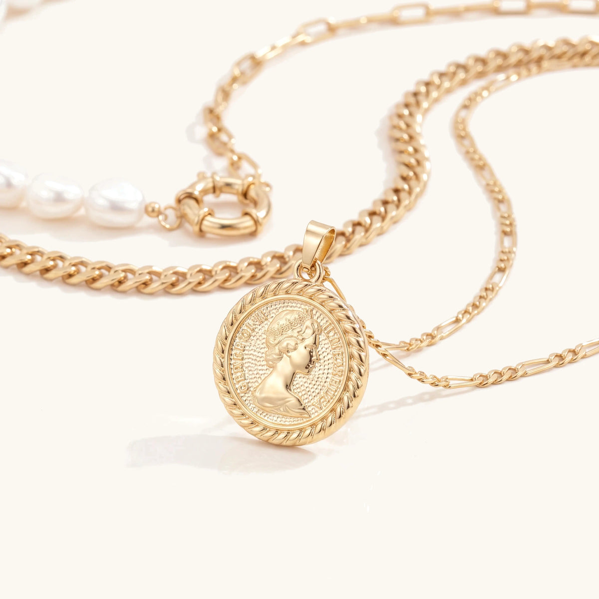 Close-up of the gold vintage coin medallion pendant on a figaro chain