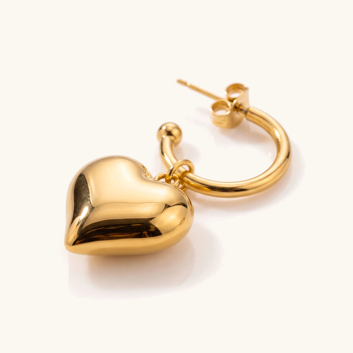 18k Dainty Heart Hoop Earring in gold, close-up of the puffy heart