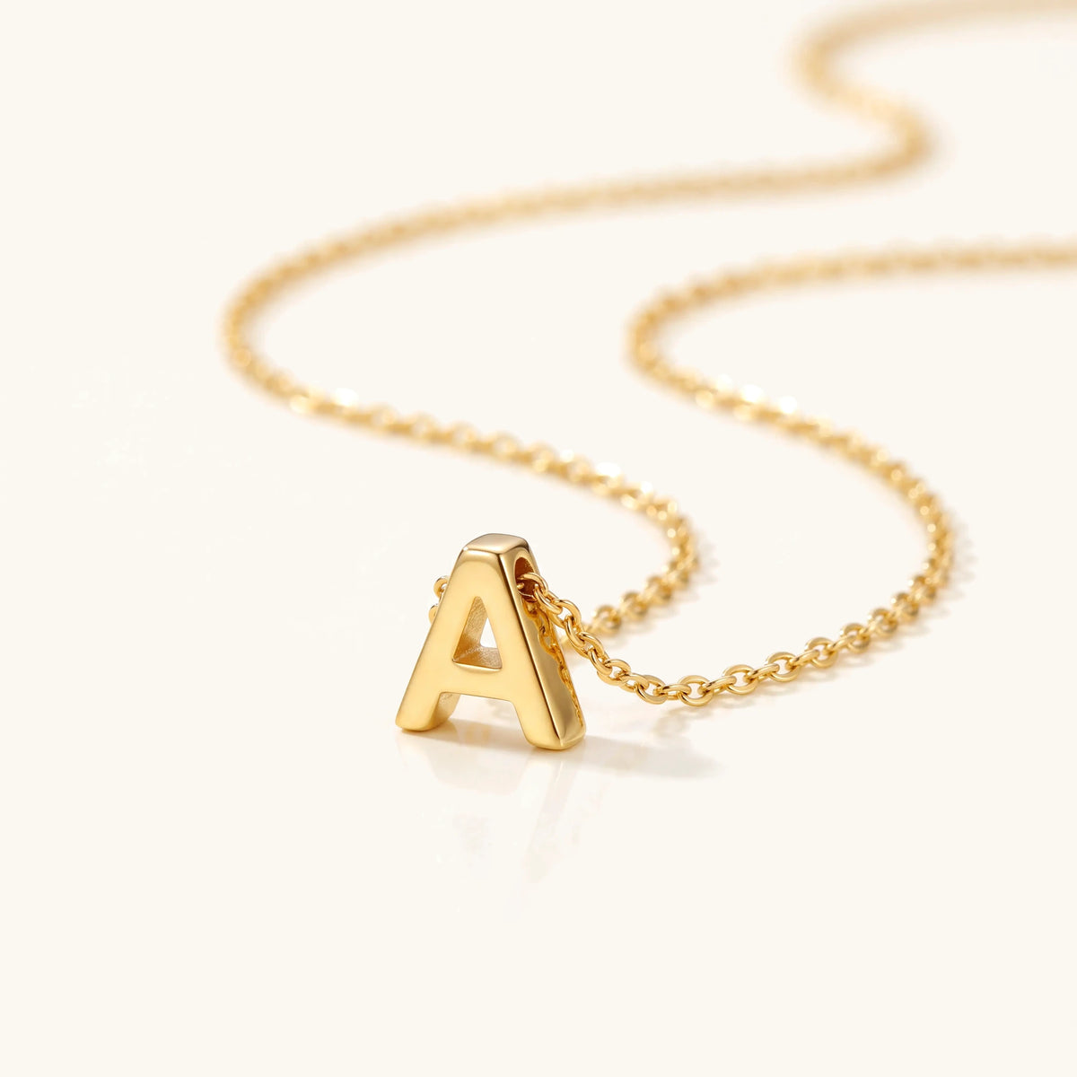 Close-up of a gold initial letter pendant