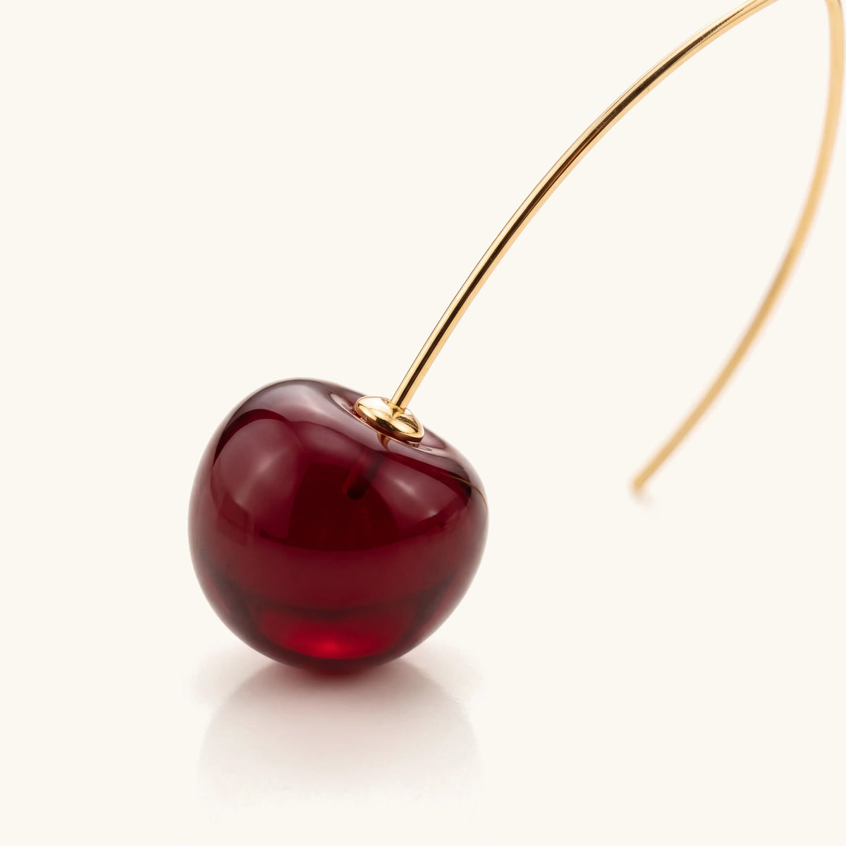 Elongated Deep Cherry Drop Earrings – close-up of the deep red cherry drop and gold detail