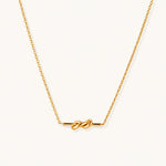 Load image into Gallery viewer, Dainty 18K gold plated necklace with infinity knot pendant on delicate chain against white background
