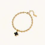 Load image into Gallery viewer, 18K gold-plated oval bead bracelet with a four-leaf clover charm in mother-of-pearl or black enamel, adjustable lobster clasp, on white background.
