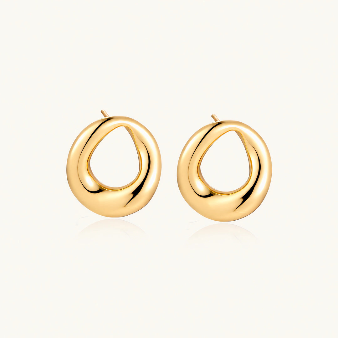 Pair of polished 18K gold-plated stainless steel teardrop earrings with hollow centers on cream background