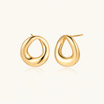 Load image into Gallery viewer, Pair of polished 18K gold-plated stainless steel teardrop earrings with hollow centers on cream background
