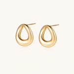 Load image into Gallery viewer, Pair of polished 18K gold-plated stainless steel teardrop earrings with hollow centers on cream background
