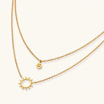 Load image into Gallery viewer, Gold layered necklace set with sunburst and smiley face pendants on delicate chains against white background.
