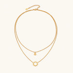 Load image into Gallery viewer, Gold layered necklace set with sunburst and smiley face pendants on delicate chains against white background.
