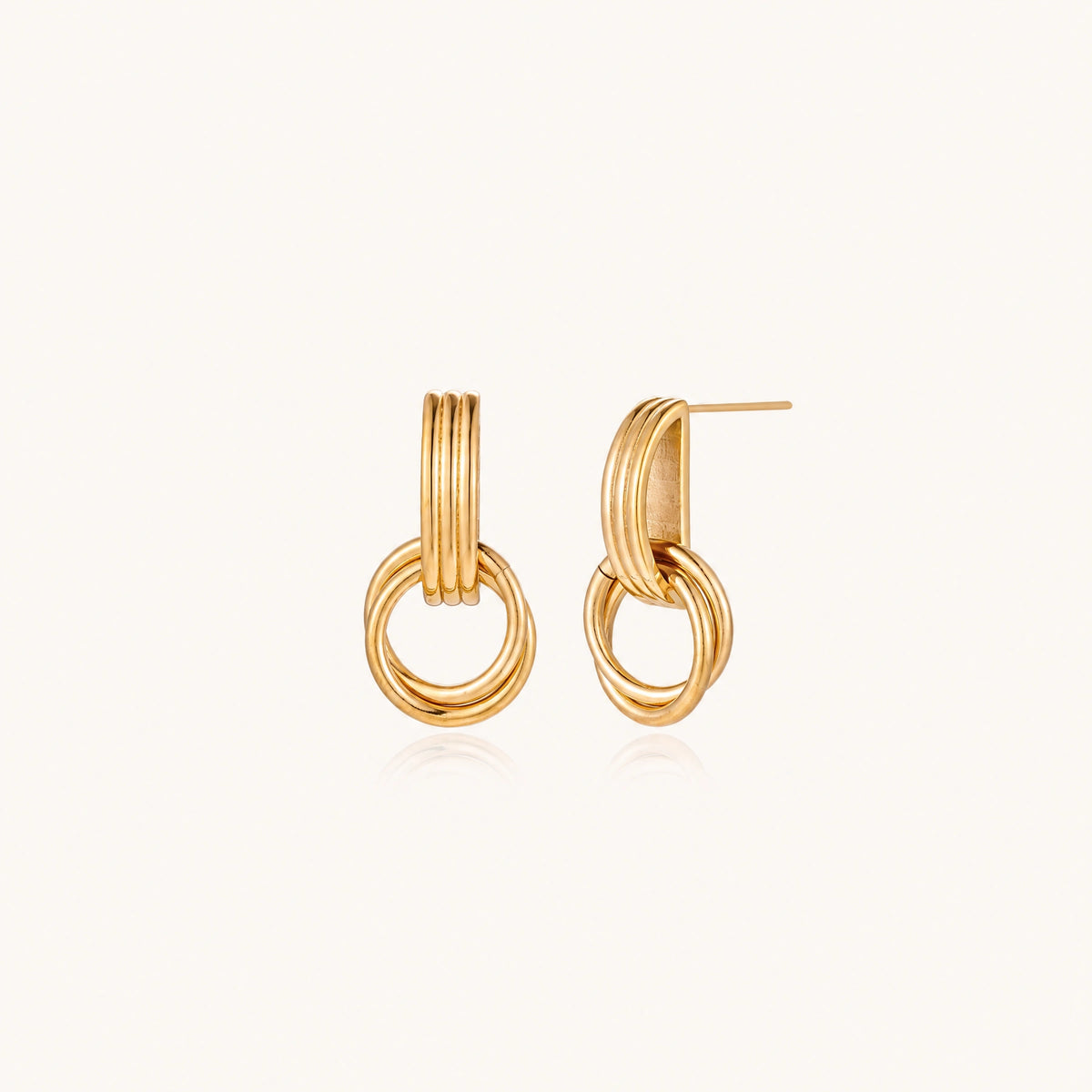 Gold stud earrings with vertical ridged bar connecting to triple interlocking circular rings on white background