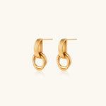 Load image into Gallery viewer, Gold stud earrings with vertical ridged bar connecting to triple interlocking circular rings on white background
