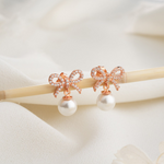 Load image into Gallery viewer, Gold Bow Pearl Dangle Earrings
