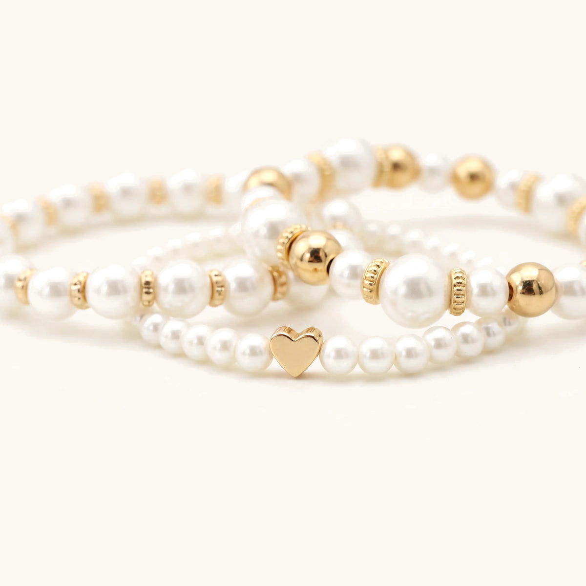 Bold Gold Accented Pearl Bracelet Stack, close-up of the pearls and gold heart