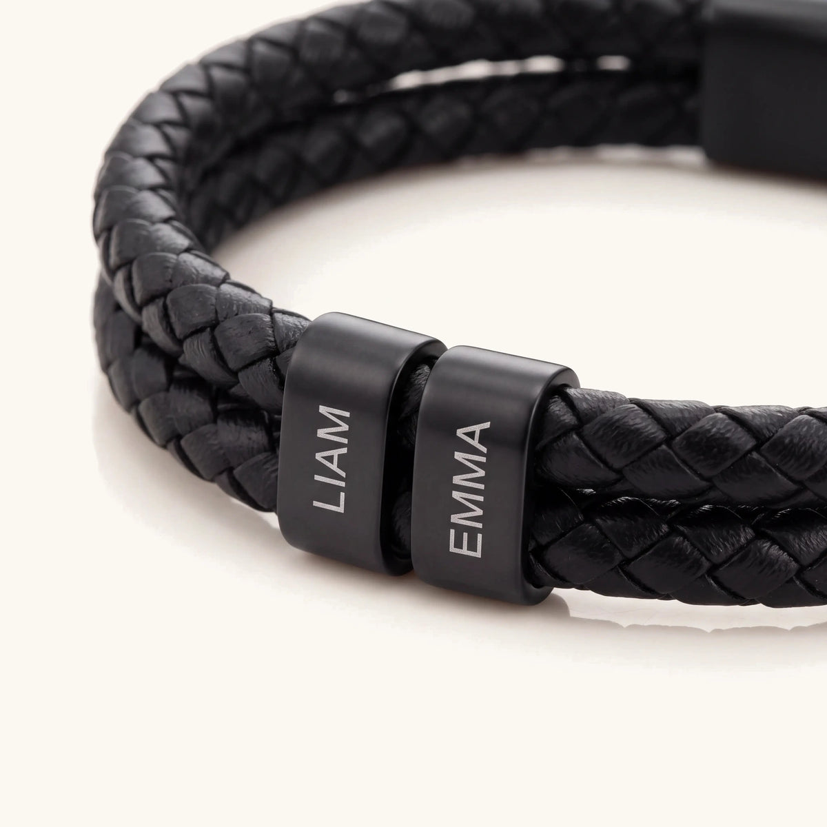 Engraved name detail on the black leather personalized bracelet