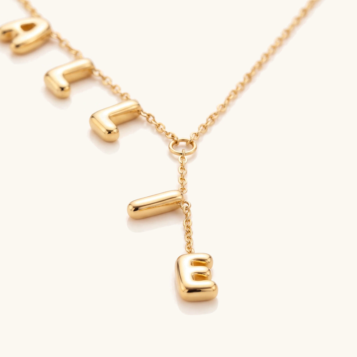 Dainty Bubble Lariat Name Necklace – close-up of the puffy gold letters on the lariat drop
