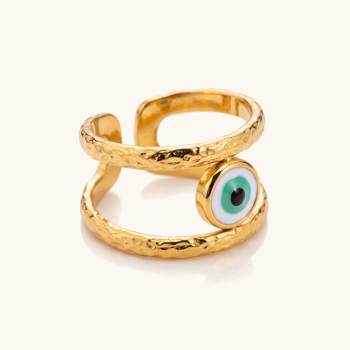 18k Bohemian Evil Eye Rings – Emerald Guardian angled close-up of the green evil eye and hammered bands