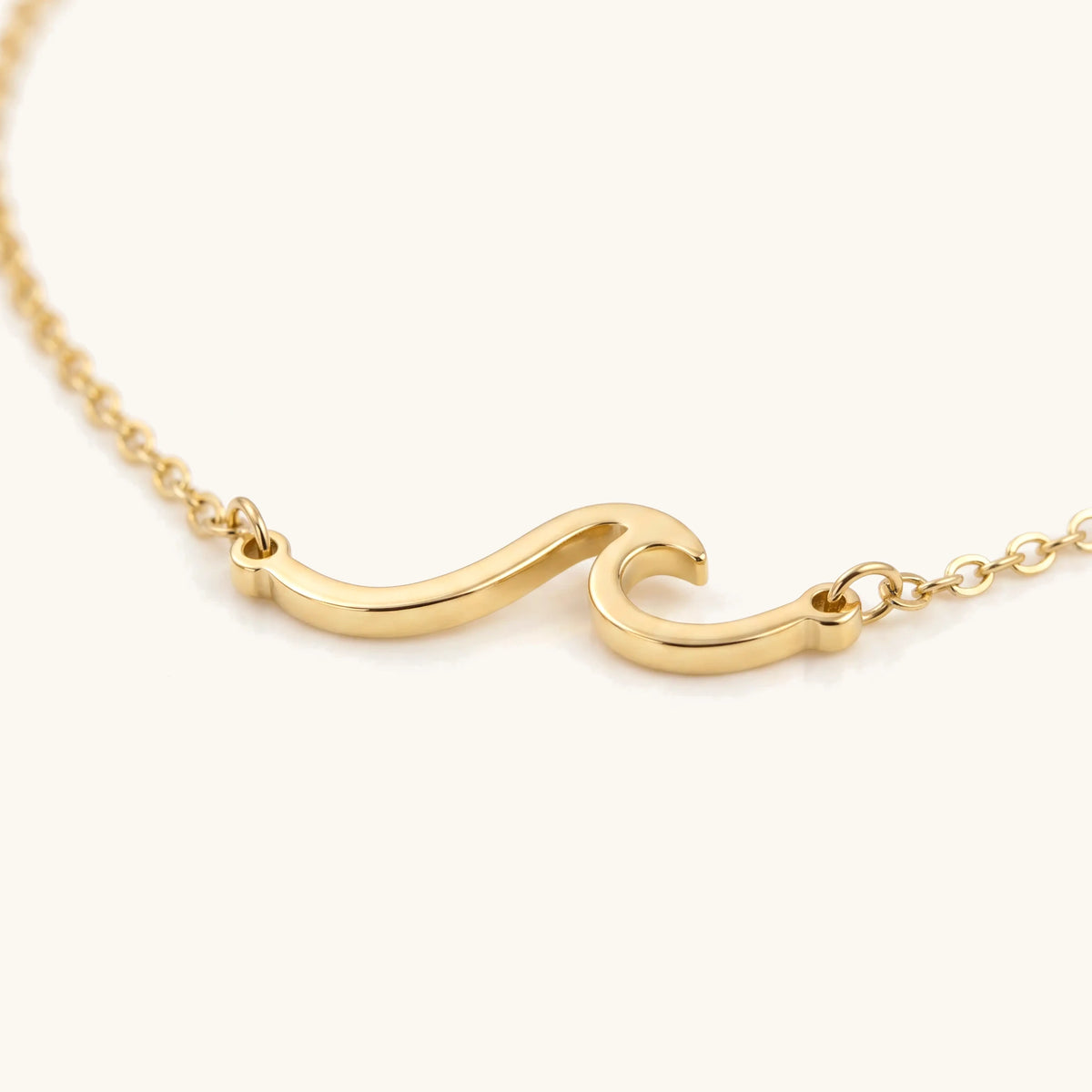Wave Anklet, close-up of the gold wave charm