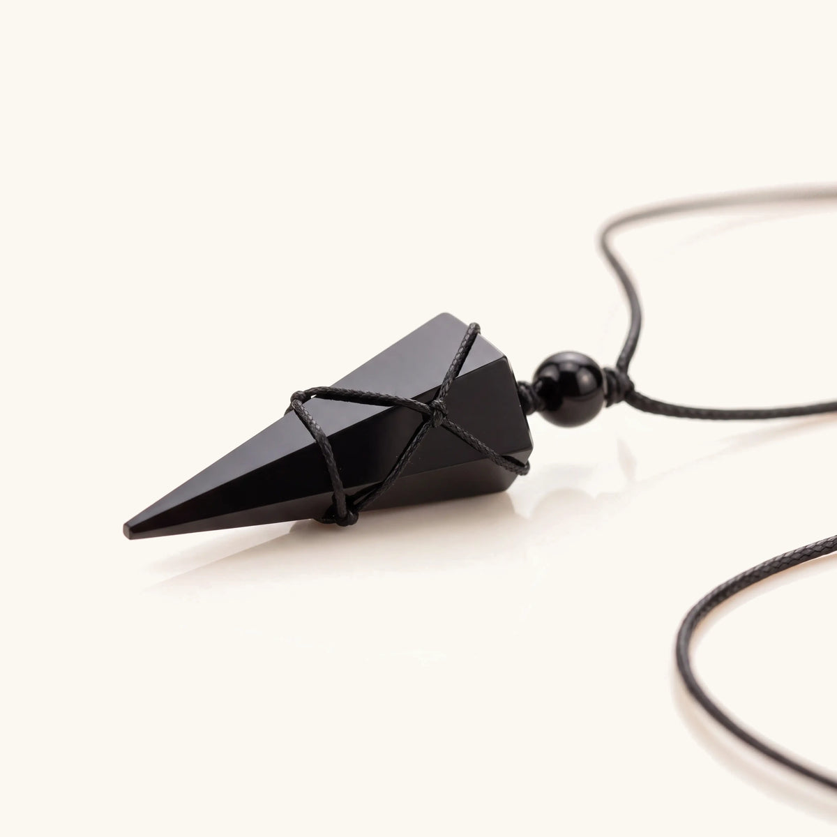 Close-up of the black obsidian arrow pendant