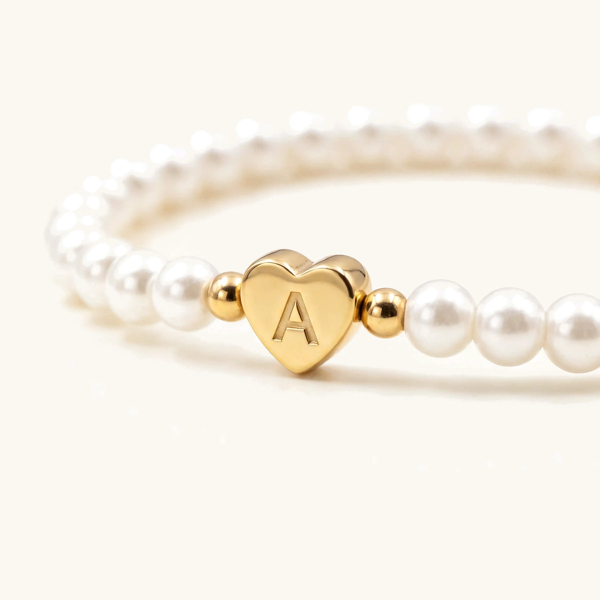 Engraved Initial Heart Bead Bracelet – close-up of the gold engraved initial heart bead
