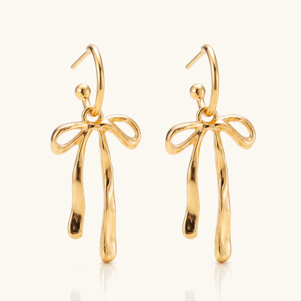 Chic Bow Hoop Earrings – pair of gold bow-shaped hoop earrings on a soft ivory background