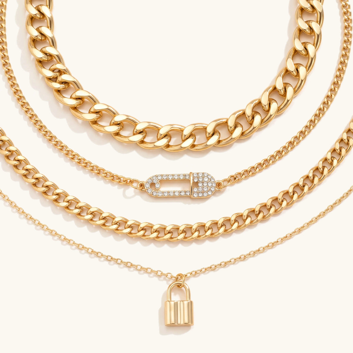 Gold 4 piece layered chain necklace set with crystal safety pin and padlock pendant