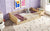 Natural Finish Twin Toddler Floor Bed with Built-in Book Storage Rack