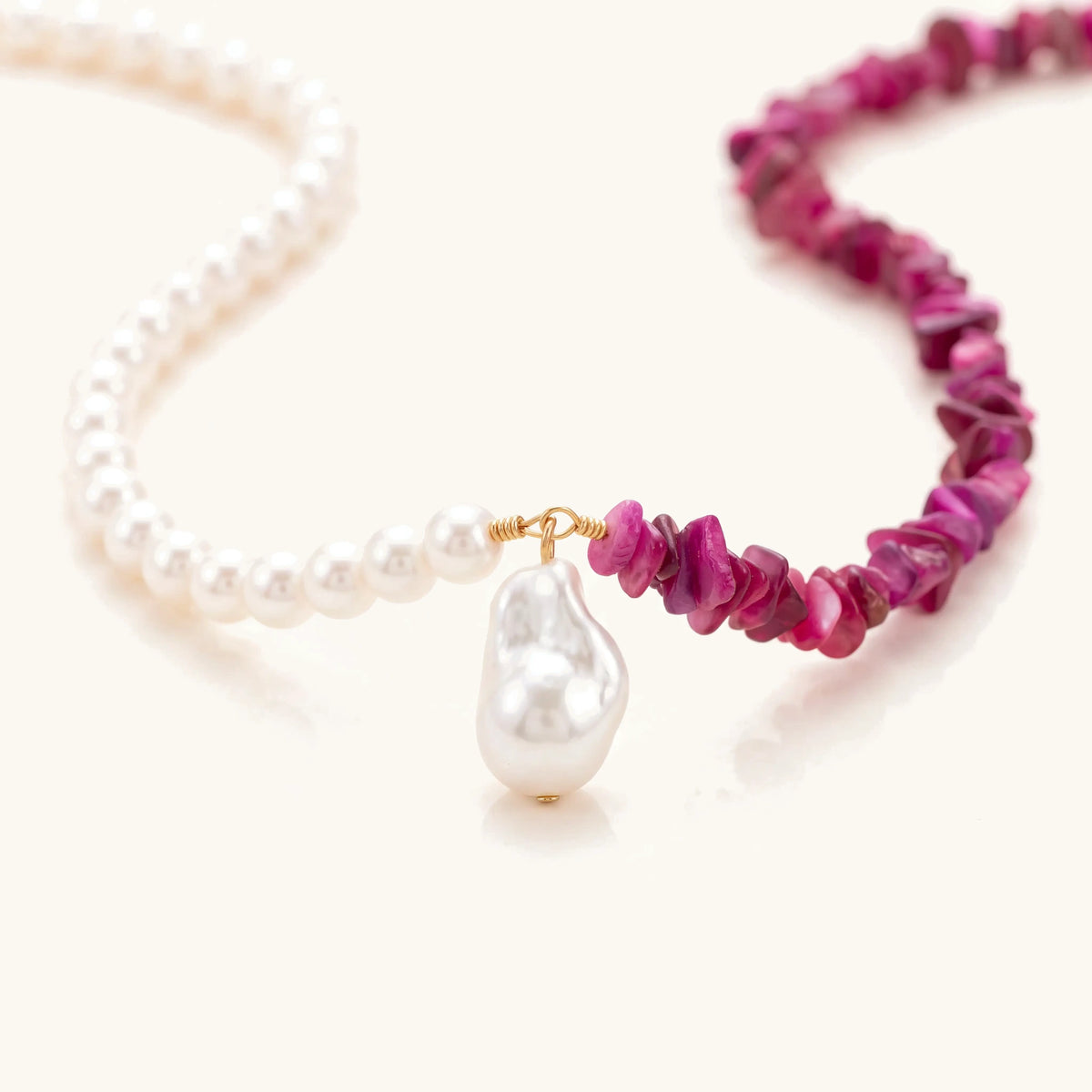 Close-up of the baroque pearl drop where the pearls meet the pink crystal chips