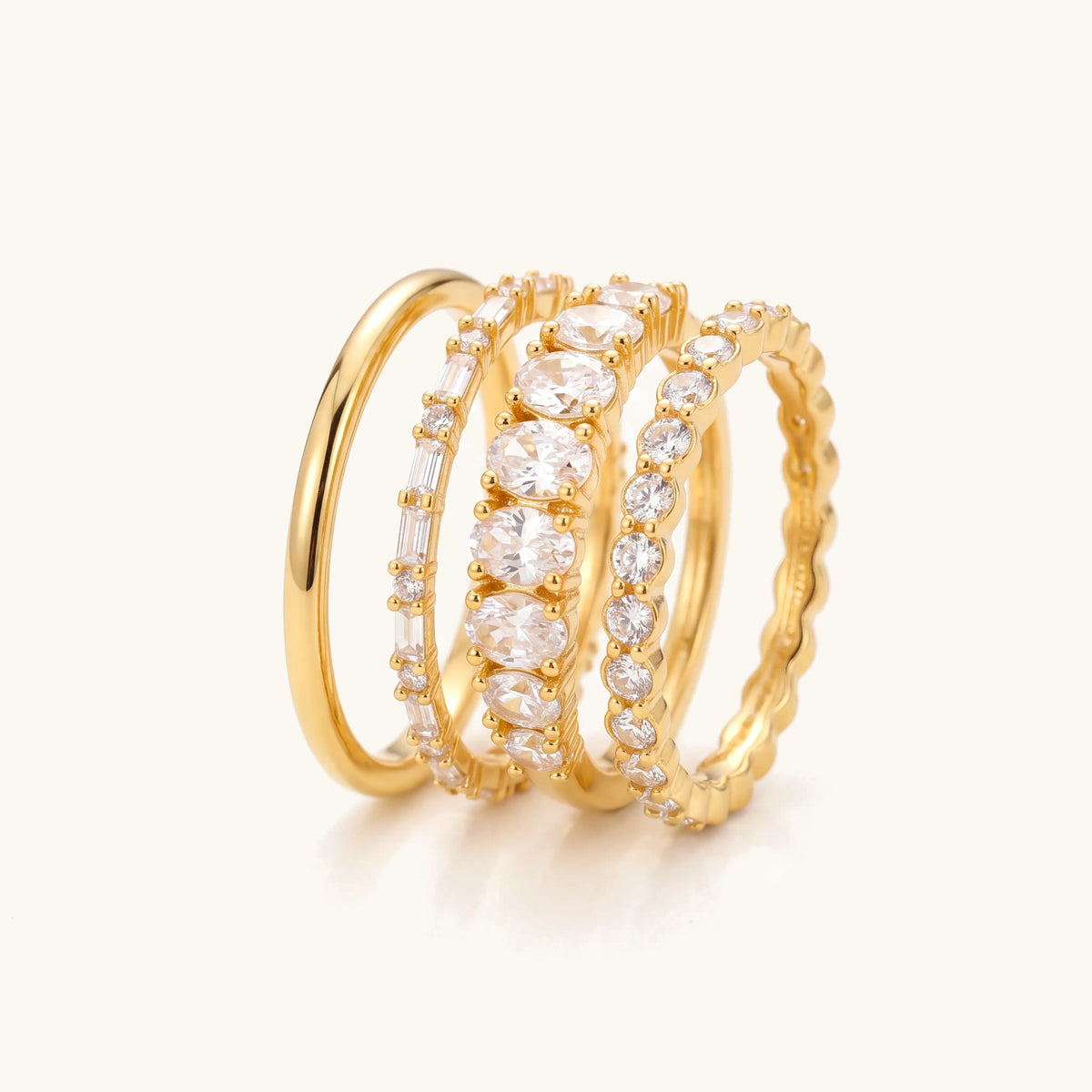14k 4pc Diamond Accented Ring Stack – four gold rings stacked on a soft ivory background