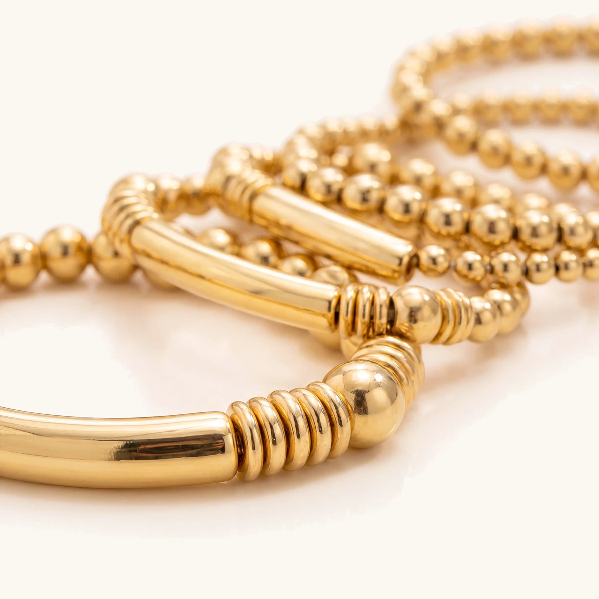 Close-up of a gold tube bar bead bracelet with ridged spacers
