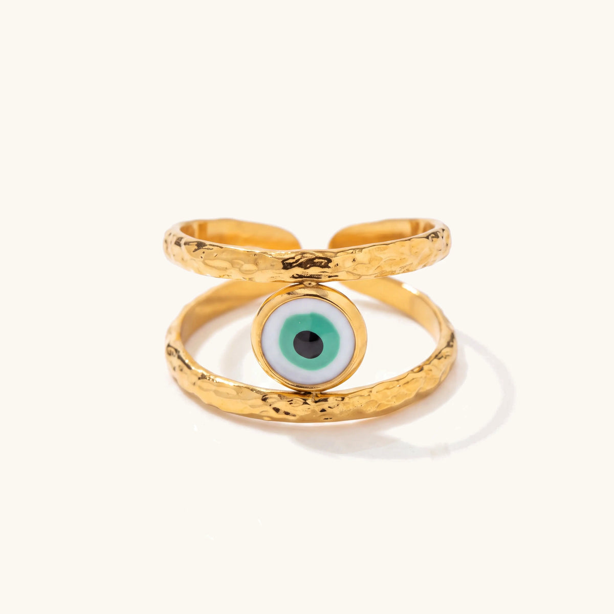 18k Bohemian Evil Eye Rings – Emerald Guardian hammered gold ring with green evil eye on a soft ivory background