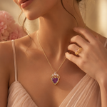 Load image into Gallery viewer, Rapunzel Crown Inspired Necklaces and Rings woman wearing a delicate gold chain necklace with a heart-shaped purple pendant and matching gold ring.
