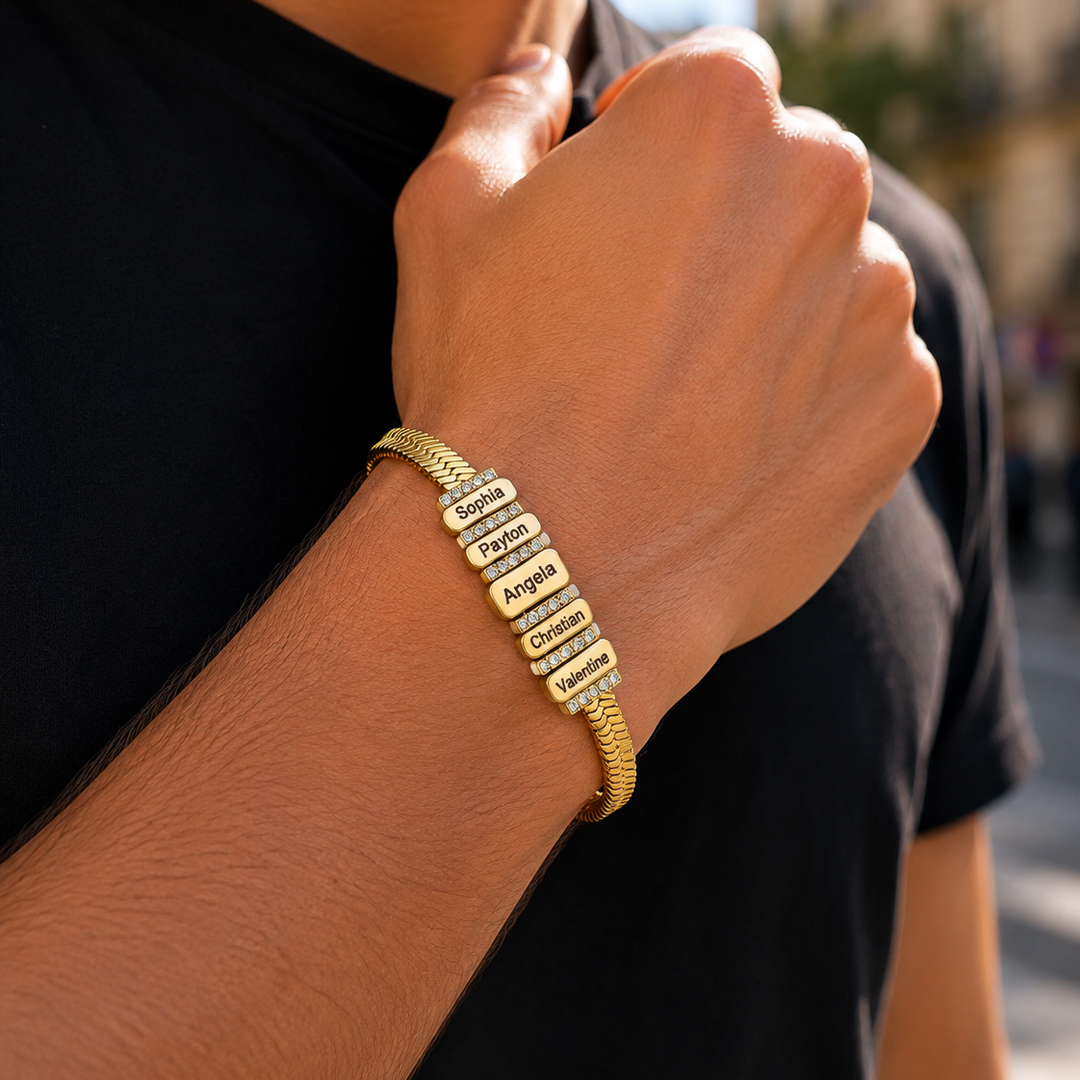 Personalized Family Name Herringbone Chain Bracelet gold bracelet with multiple rectangular nameplates engraved with initials displayed on a neutral background.