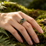 Load image into Gallery viewer, Classic Green Pearl Vintage Earrings close-up of a hand wearing an ornate gold ring with green and dark blue floral enamel detailing.
