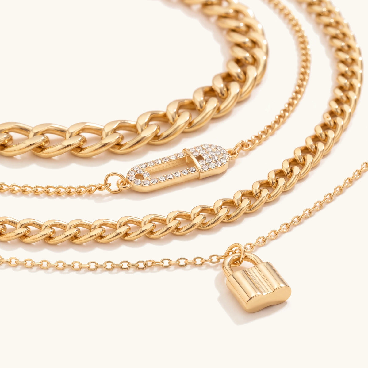 Close-up of the crystal safety pin connector and gold padlock pendant