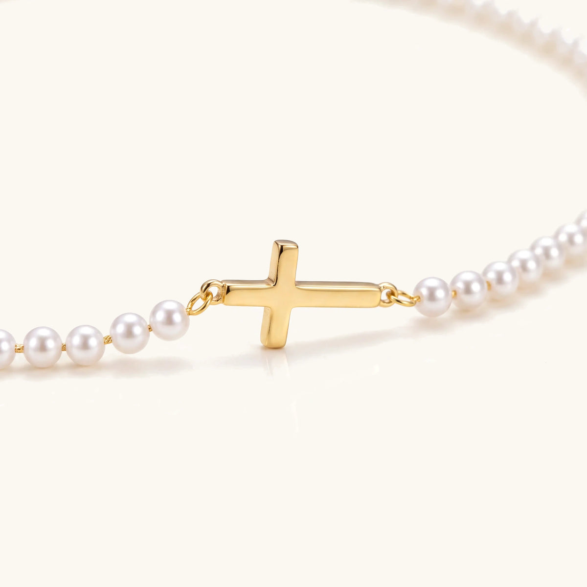 Dainty Faux Pearl Cross Station Choker, close-up of the gold cross