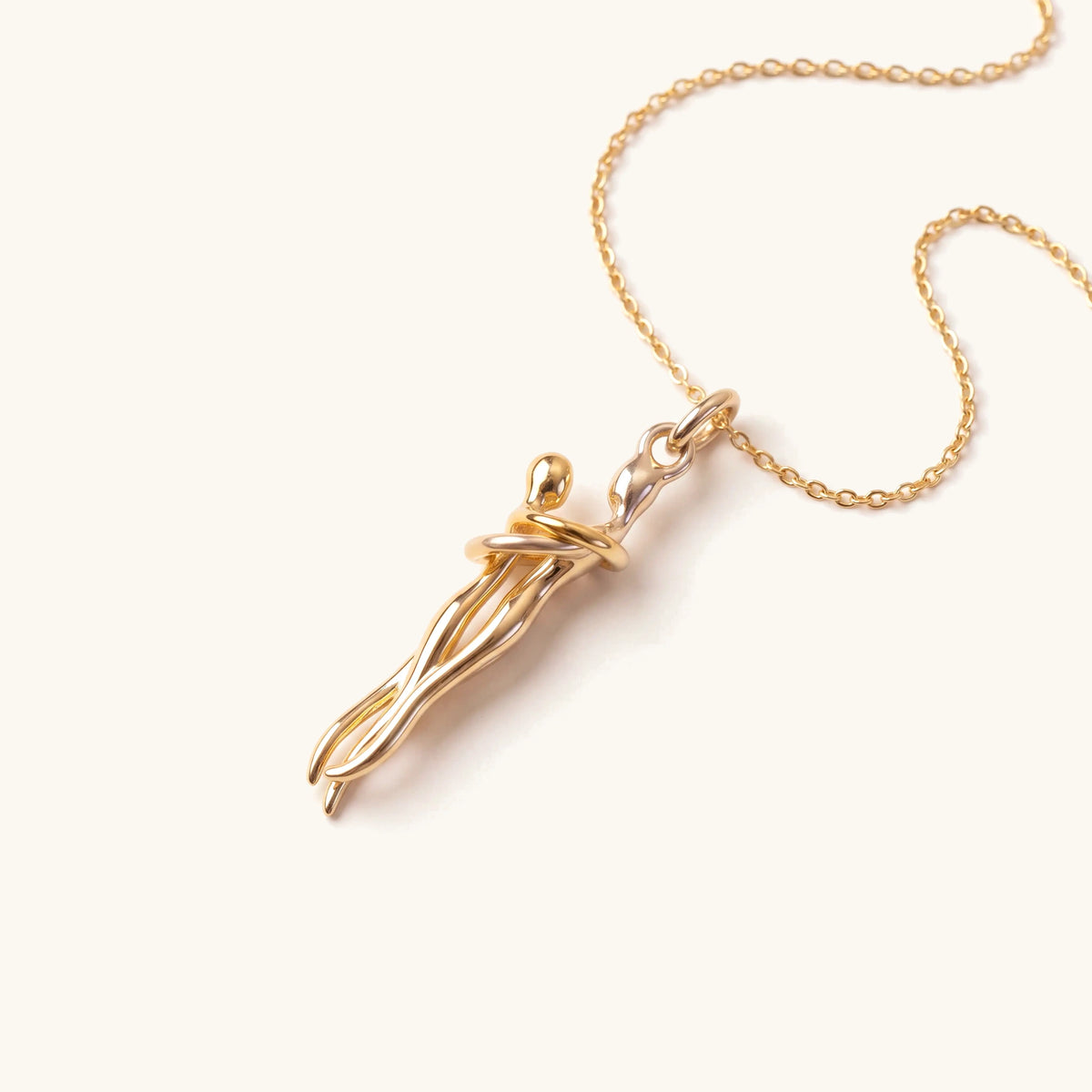 Love Hug Pendant Couple Embrace Necklace in gold, flat lay