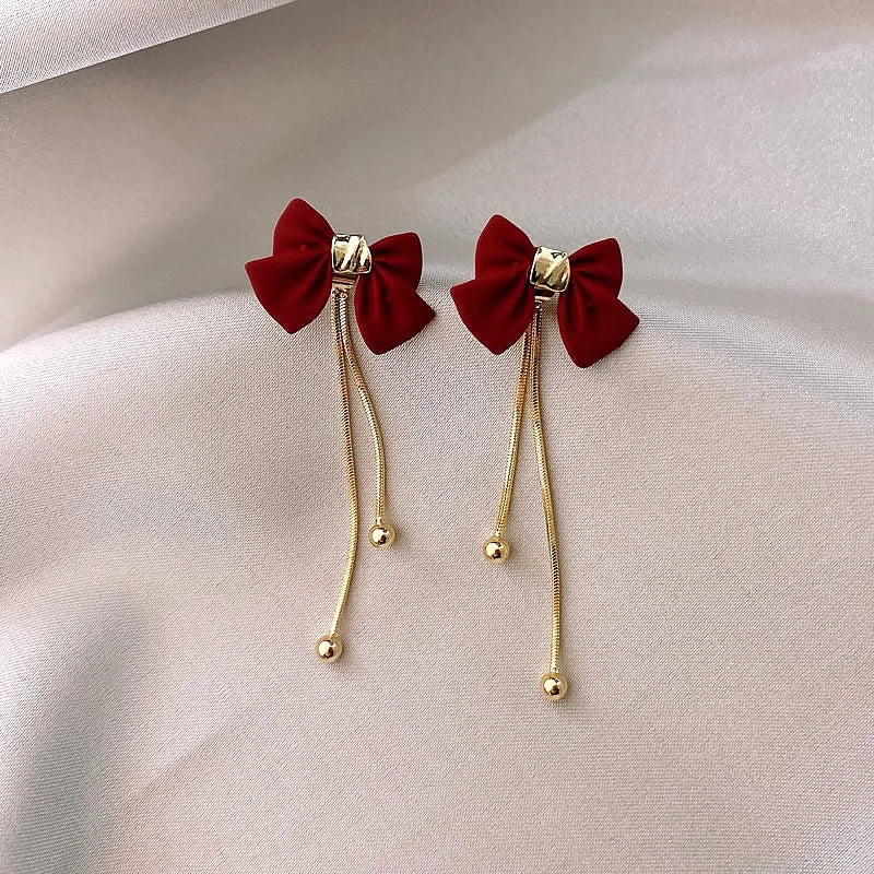 Dainty bow gold dangle earrings 360778