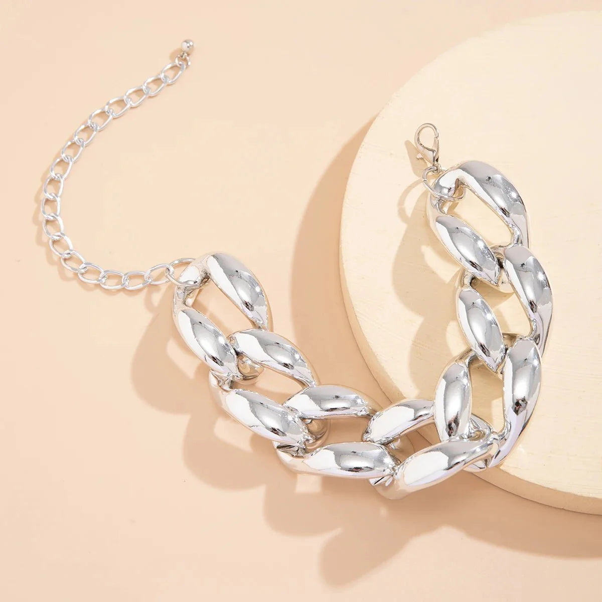 Exaggerated Chunky Cuban Link Choker Necklace silver chunky Cuban link chain displayed on a beige background.