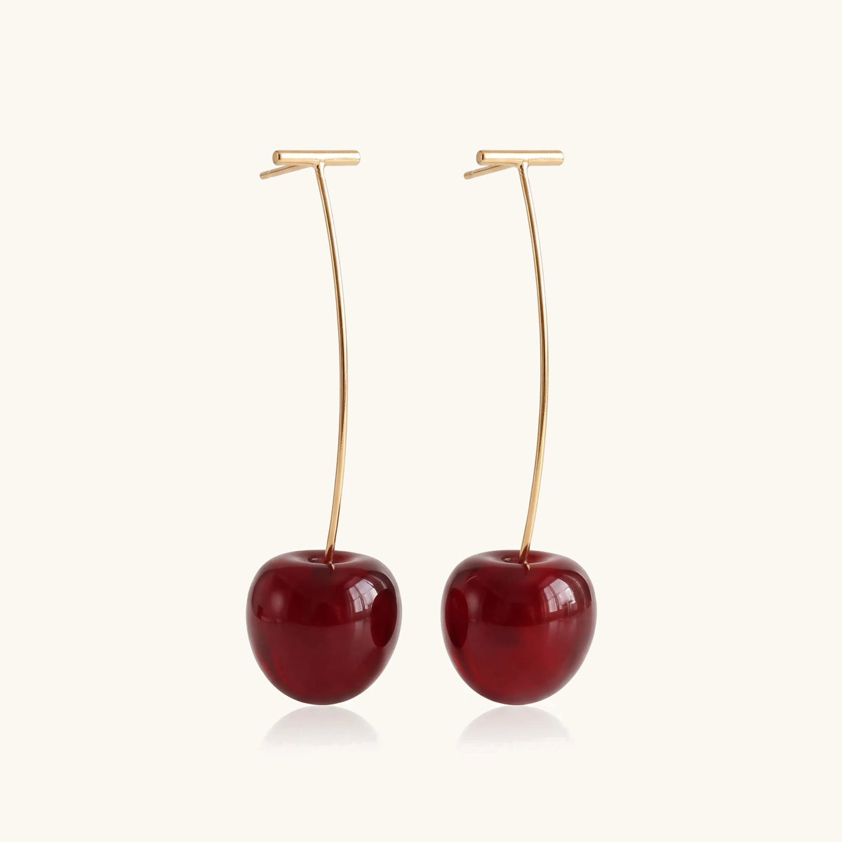 Elongated Deep Cherry Drop Earrings – pair of gold earrings with deep red cherry drops on a soft ivory background