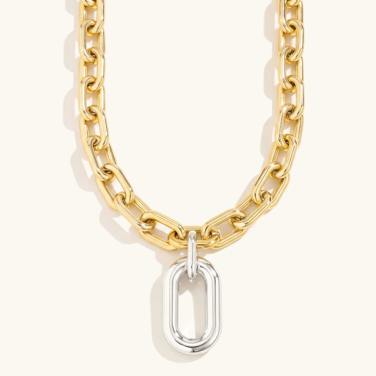 Chunky two tone paperclip necklace with gold links and silver oval drop