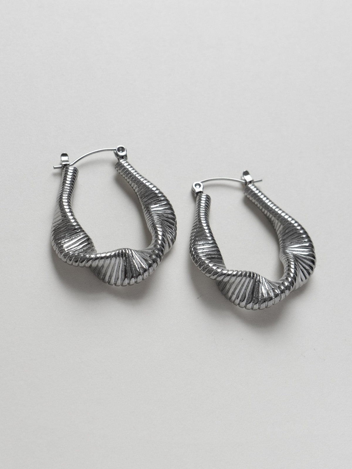 Lyra silver flowing wave hoop earrings